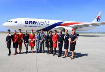 Flight attendents showing off MH oneworld livery