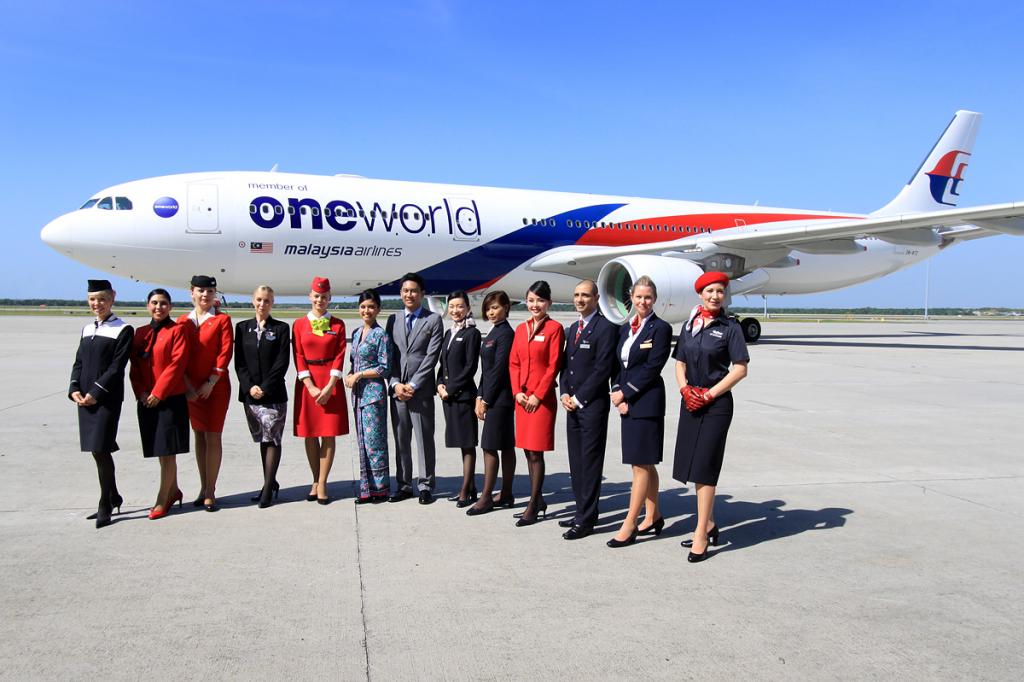 Flight attendents showing off MH oneworld livery